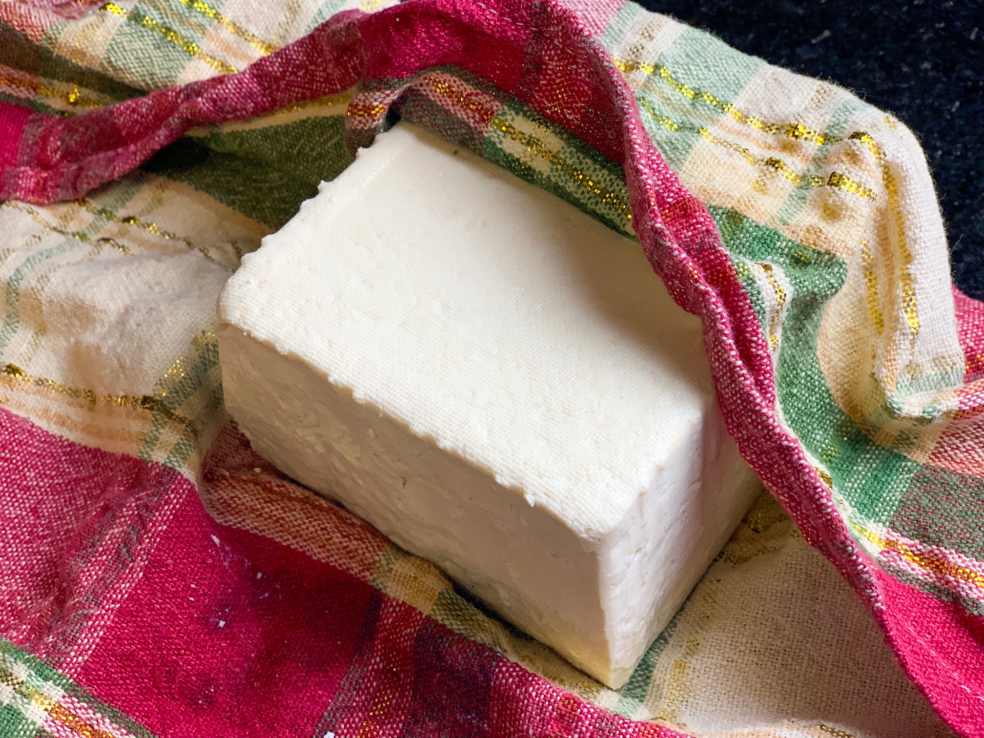 draining tofu in a towel ready for prep