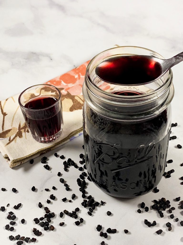 spoon holding vegan elderberry syrup recipe