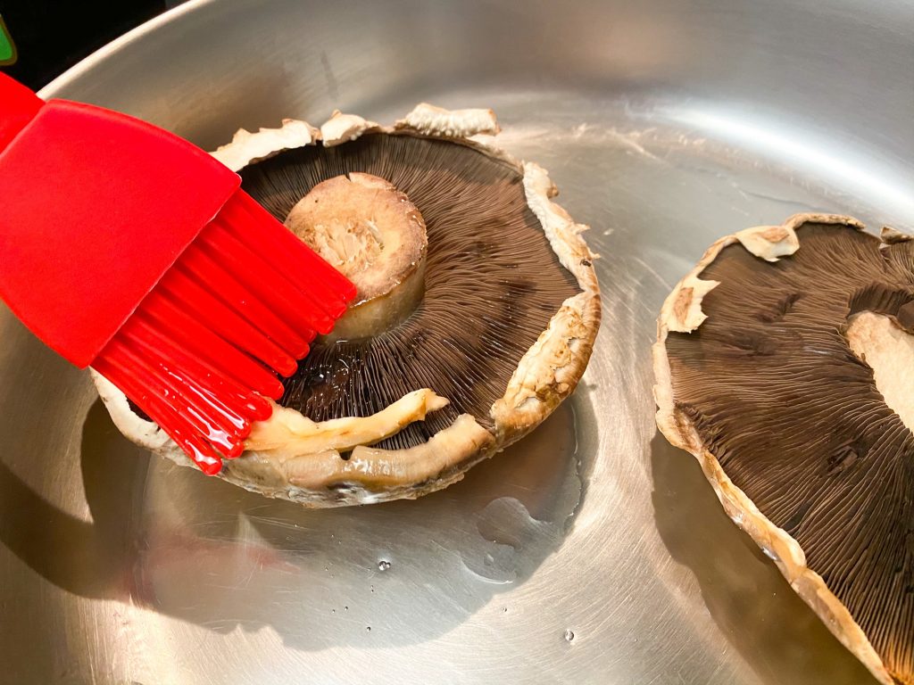 brushing Portobello steaks with oil