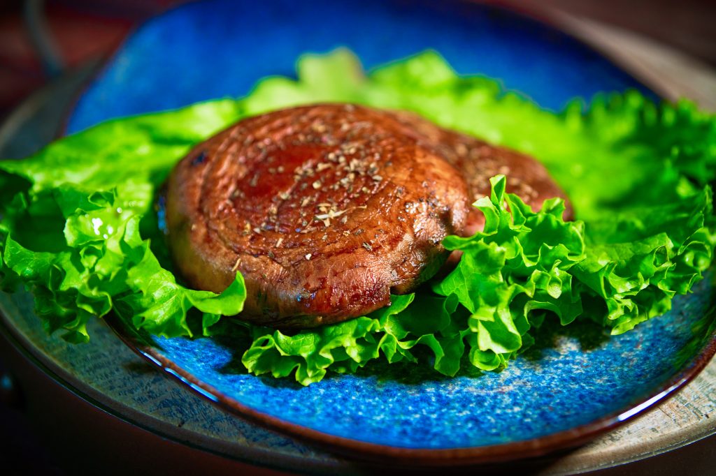 Easy and delicious vegan Portobello steaks on a bed of lettuce
