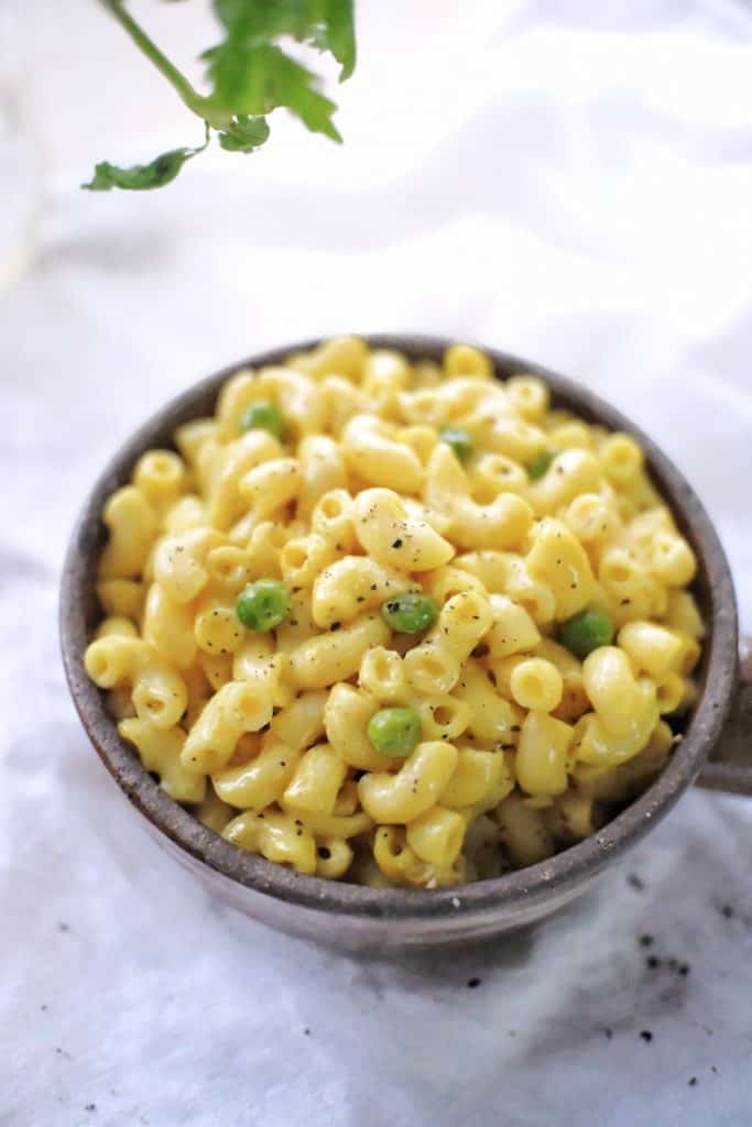 Photo of a dark bowl containing vegan mac and cheese. A must have in your vegan recipes for kids!