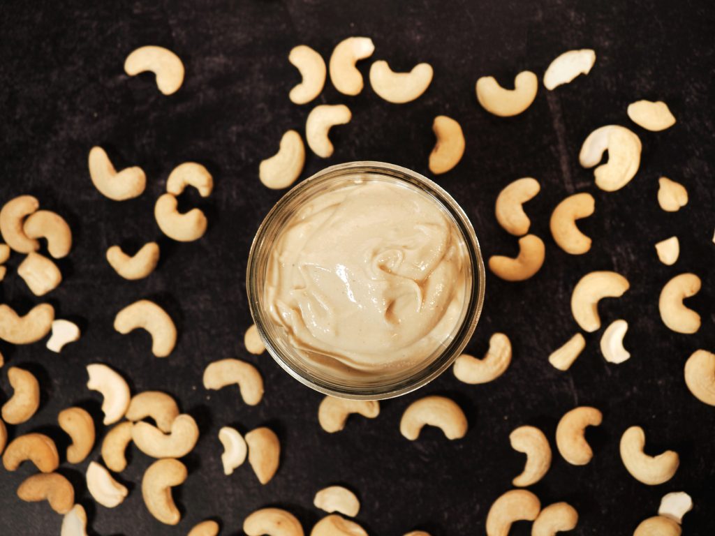 finished cashew butter with nuts on black countertop