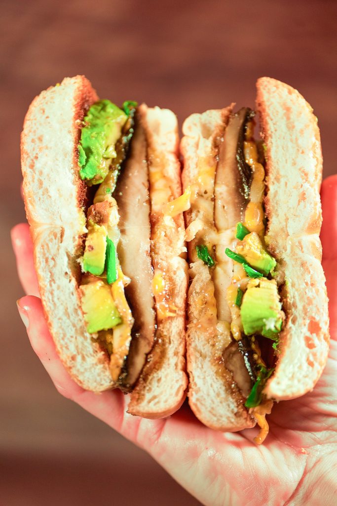 vegan portobello mushroom burger held sideways