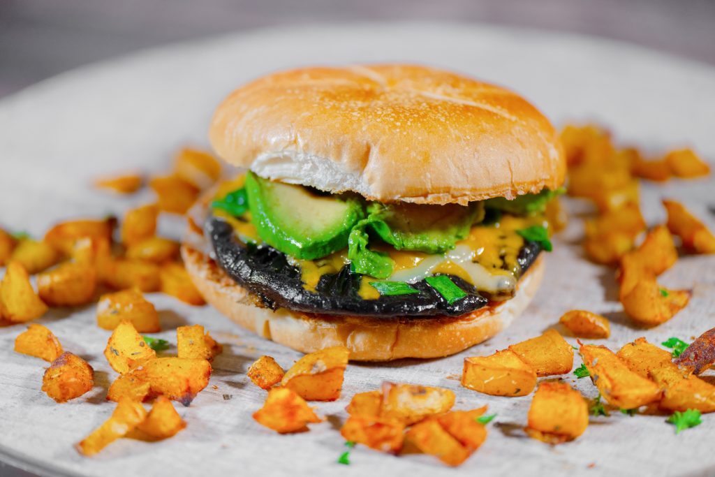 vegan portobello mushroom burger with avocado and potatoes