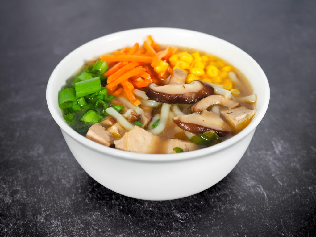 warm bowl of udon noodles with vegan broth