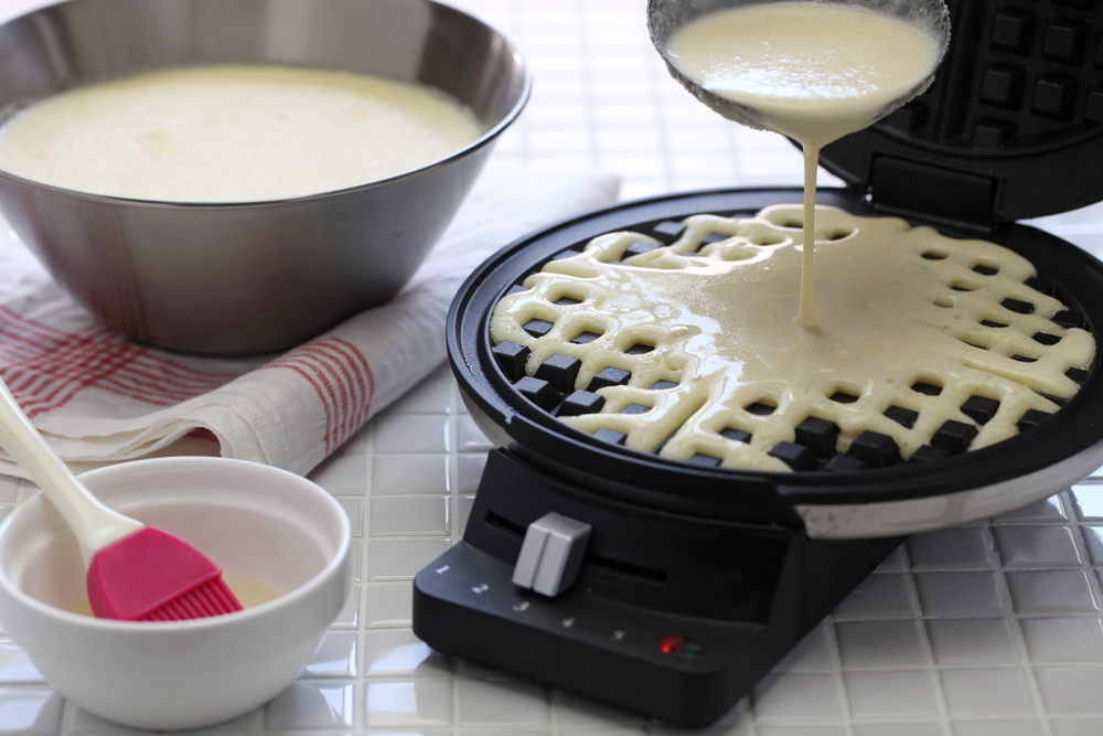 pouring batter on waffle maker with removable plates