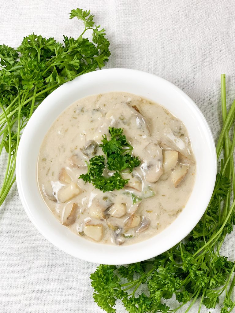 Photo of a round white bowl serving 5-ingredient vegan clam chowder which is a great vegan kids recipe
