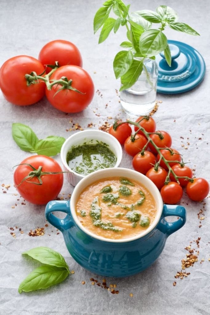 Photo of roasted tomato and fennel soup being served in a small blue pot. 