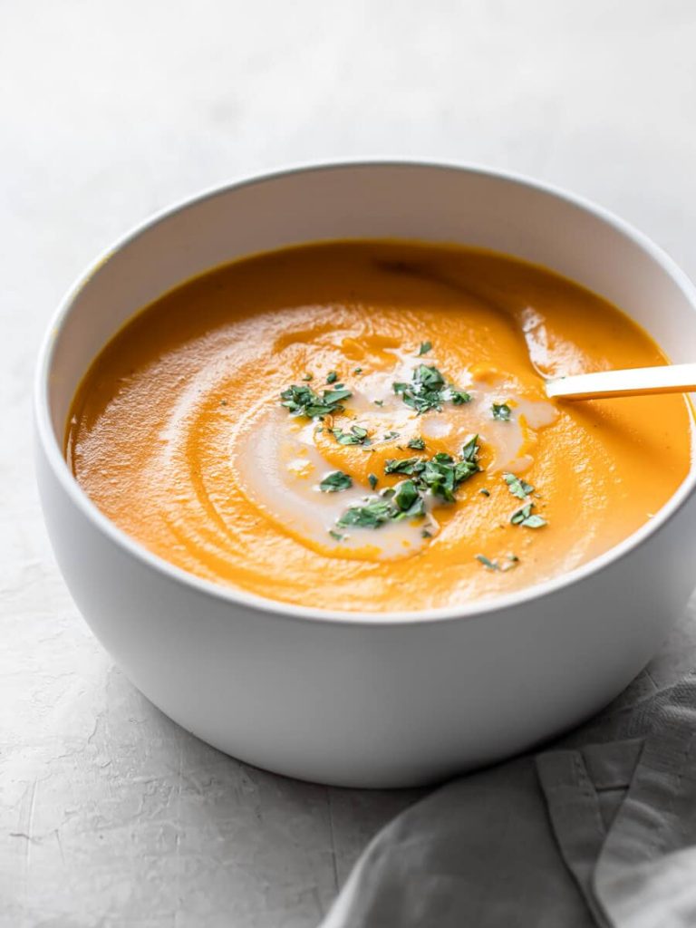 Photo of a small bowl serving sweet potato soup. One of the very creamy vegan soup recipes.