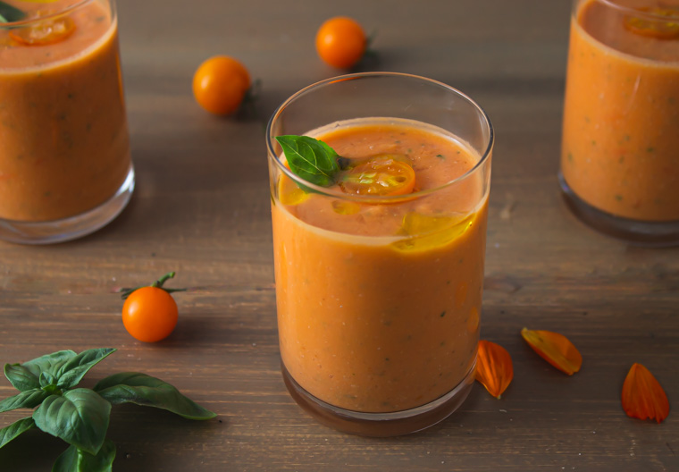 Photo of three glasses serving sweet corn and tomato gazpacho. One of the rare cold soups among vegan soup recipes. 