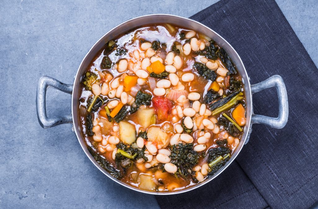 Photo of a large pot of vegetable and bean soup.