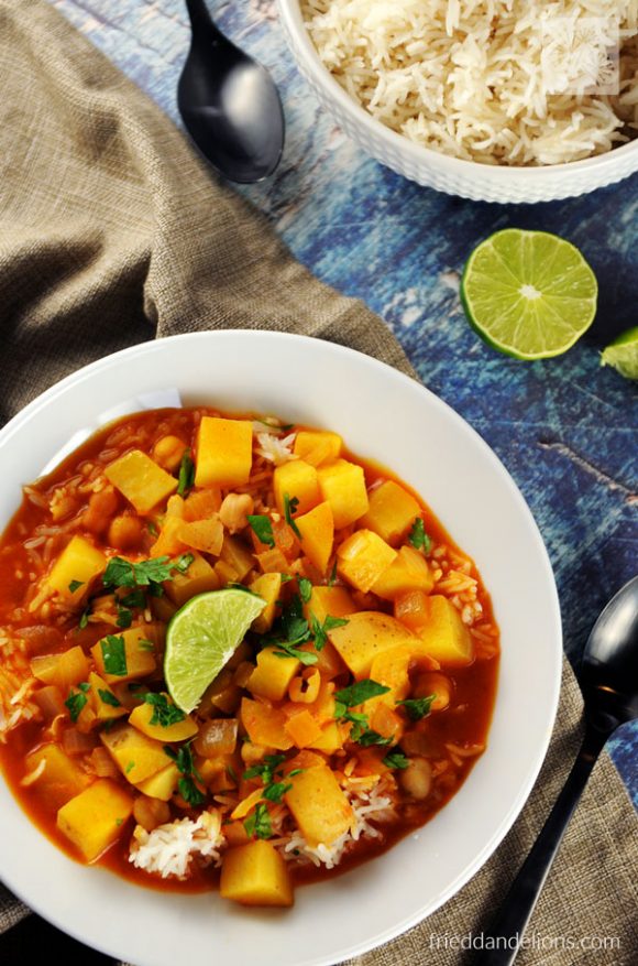 Photo of pumpkin curry soup being served in a round white bowl. 