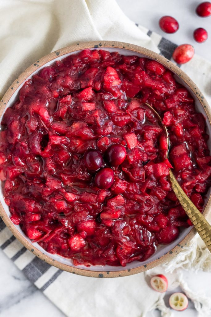Photo of homemade cranberry sauce being served in a large round bowl.