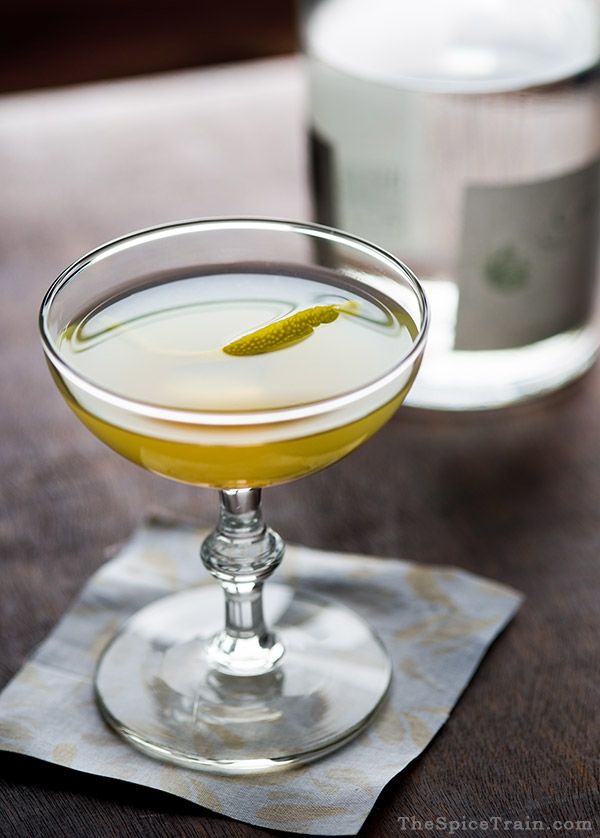 Photo of the bee's knees cocktail being served with a simple rind garnish. One of the more elegant among the easy cocktails to make at home.
