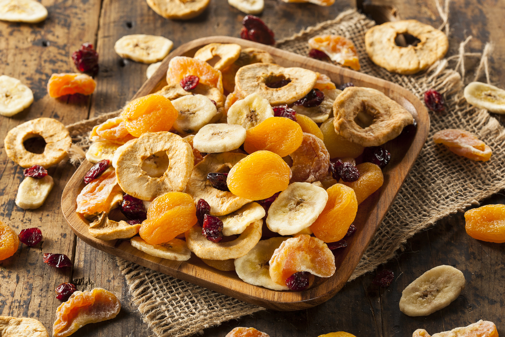 dehydrated fruits is one of the many things you can make in a food dehydrator. The photo shows dehydrated apricots, pineapple, bananas and cranberries