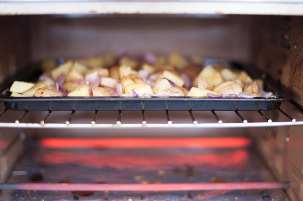 Roasted potatoes cooking in a toaster oven