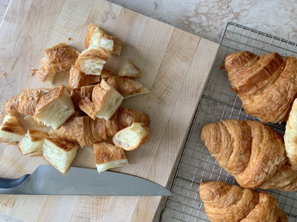 croissants being cut on cutting board