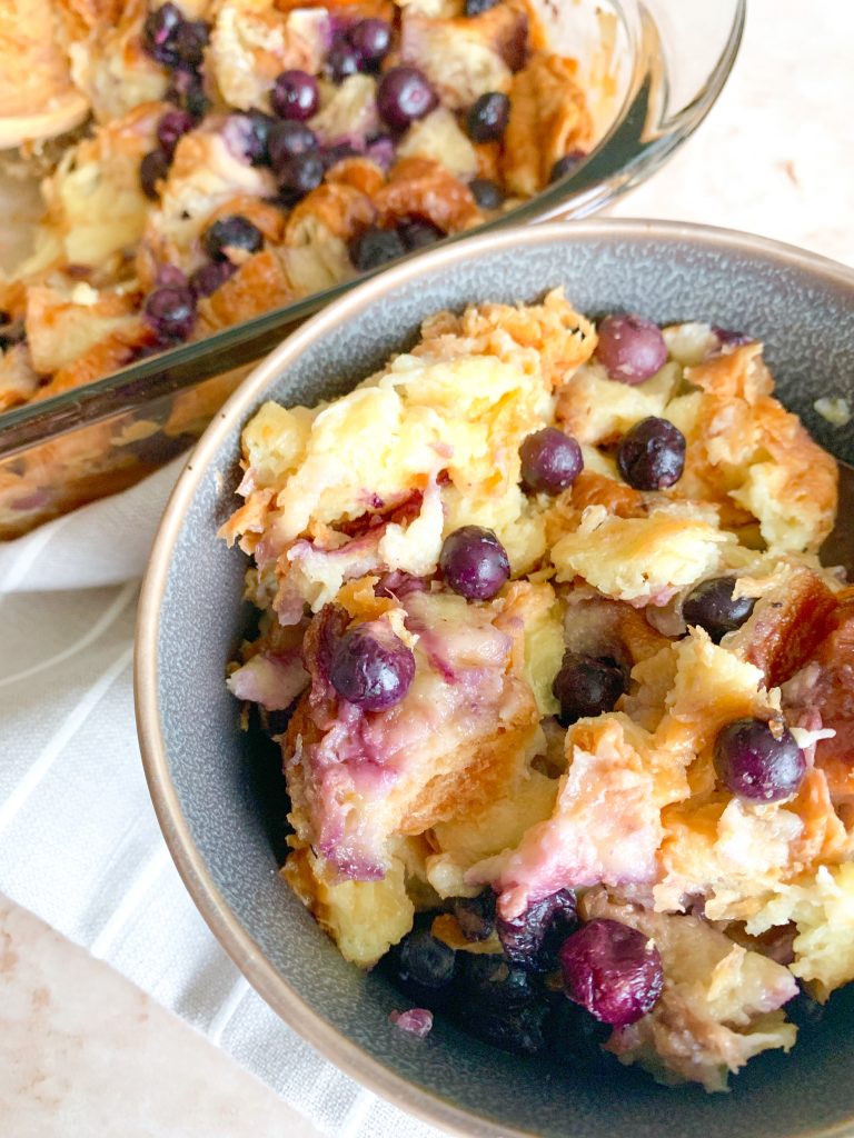 bowl of croissant bread pudding with blueberries