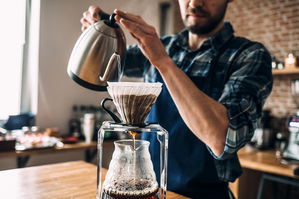 Man preparing a pour over coffee. Of all the different types of coffee this is the one you can most control. 