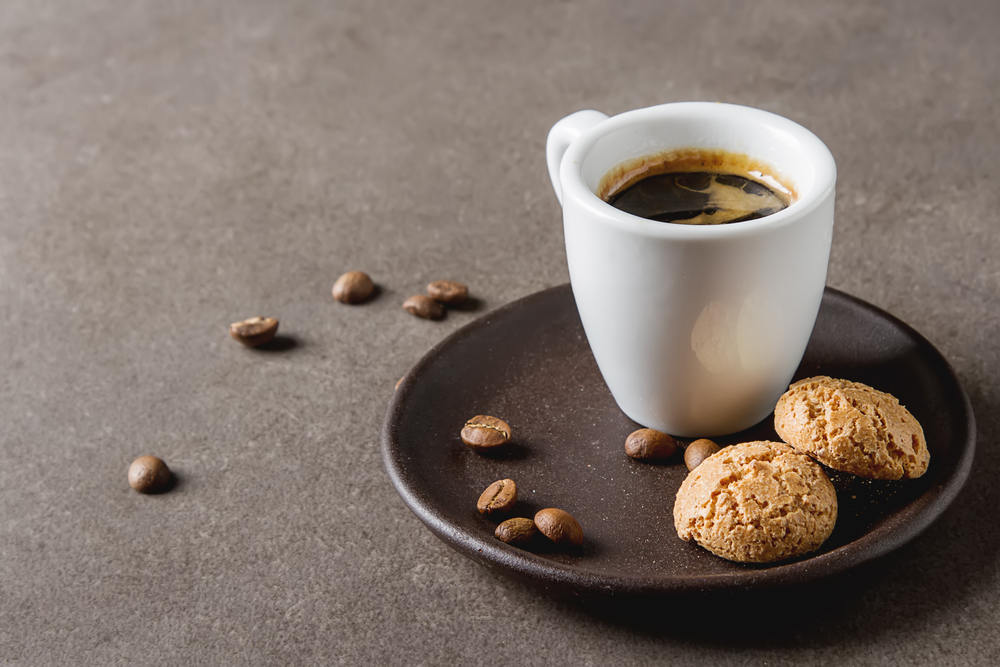 espresso on table with biscuits 