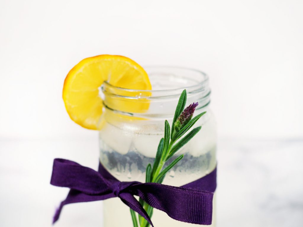 lavender stem on the outside of cup of lemonade