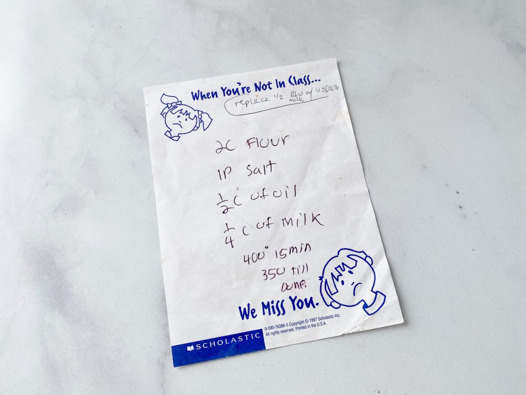 hand written recipe for pie crust on a marble counter.