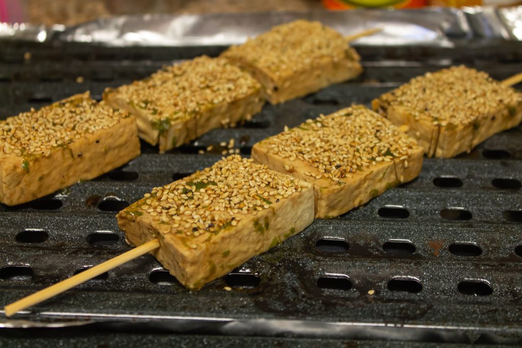 sesame tofu ready for baking on skewer