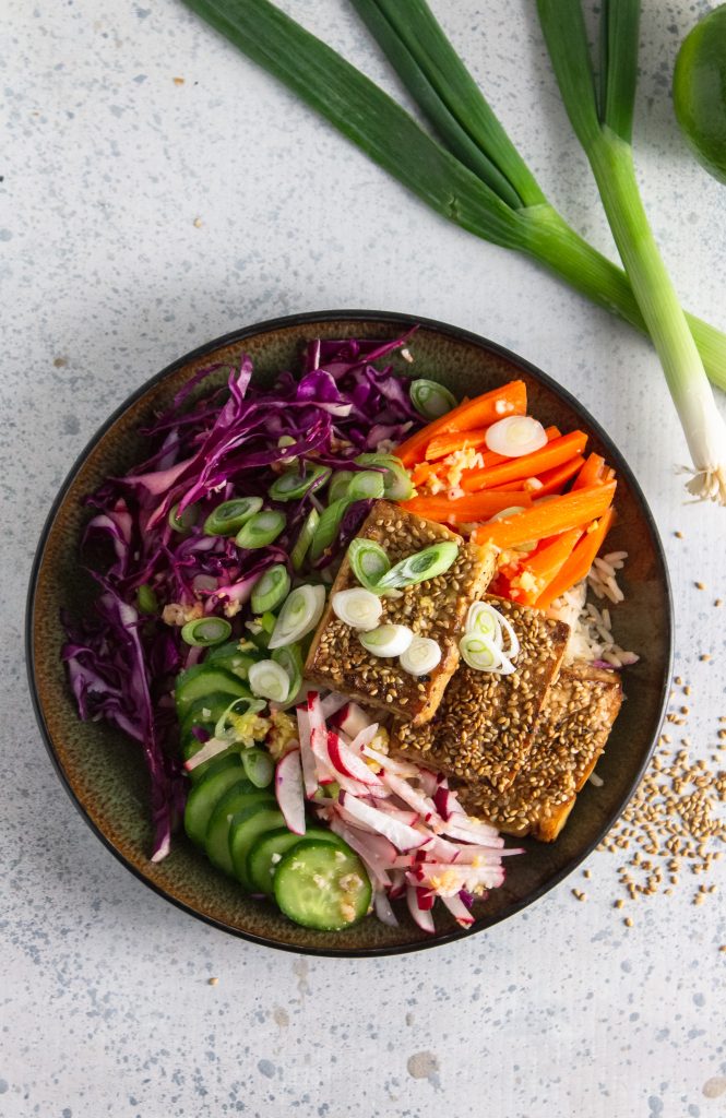 above view of vegan power bowl using tofu crusted with sesame seeds