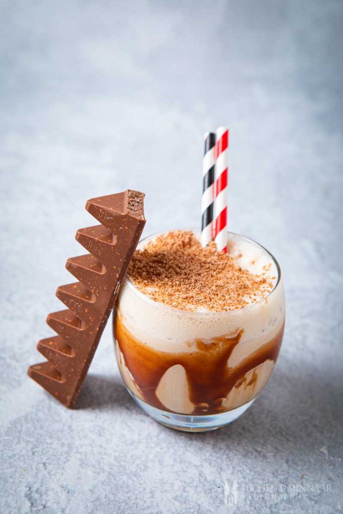 Photo of the toblerone cocktail being served with chocolate shavings on top. One of the more decadent among the easy cocktails to make at home.
