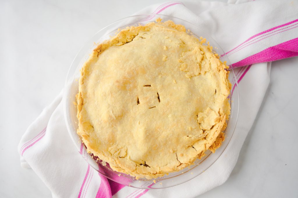 flaky vegan apple pie on pink dish towel