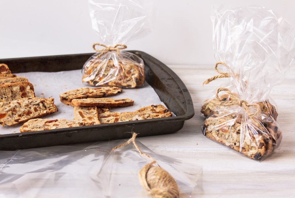 vegan biscotti wrapped in small bags on pan