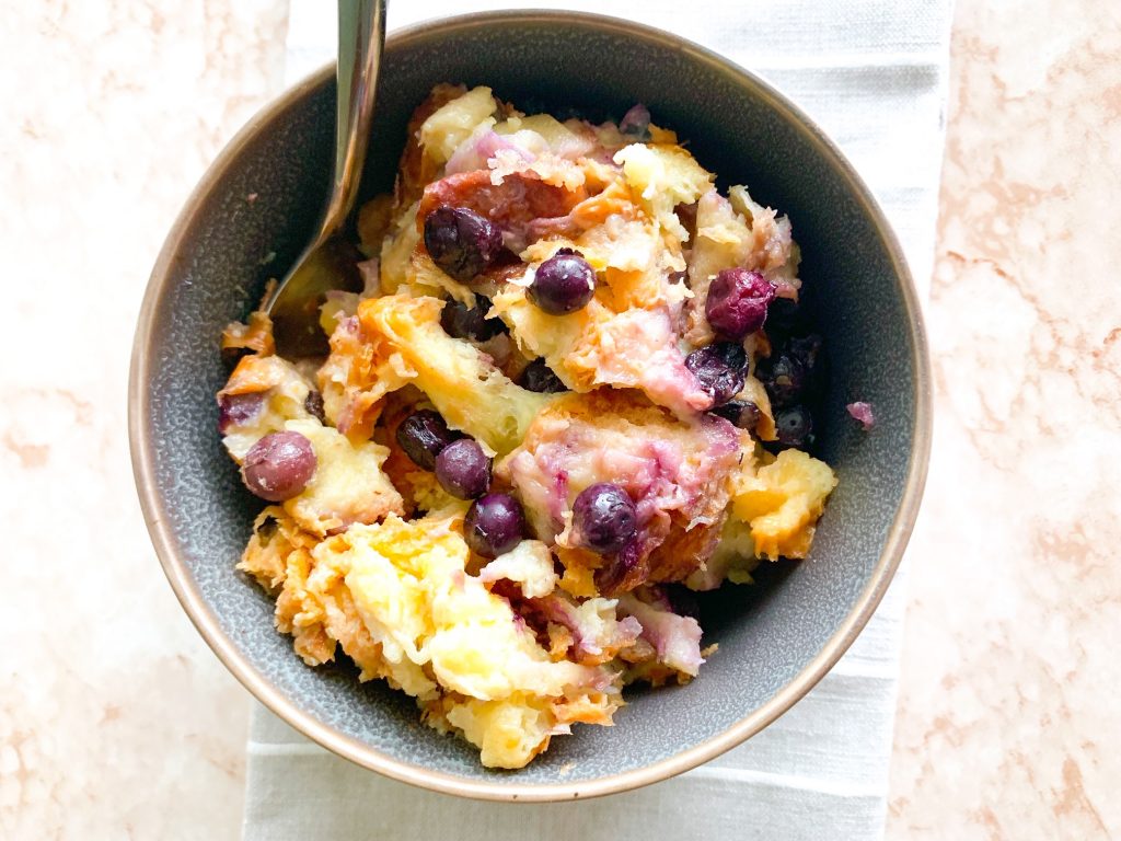 bowl of vegan bread pudding with blueberries in bowl