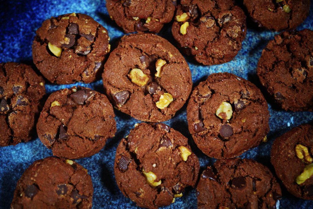 close up view of vegan chocolate cookies on blue plate