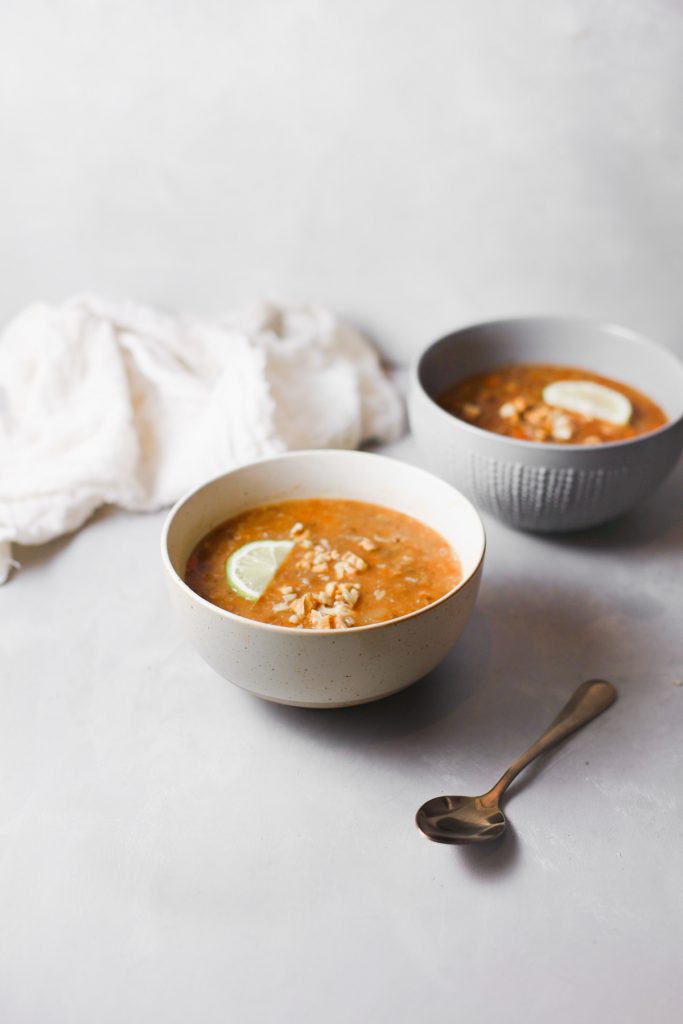 two bowls of vegan lentil soup on white counter