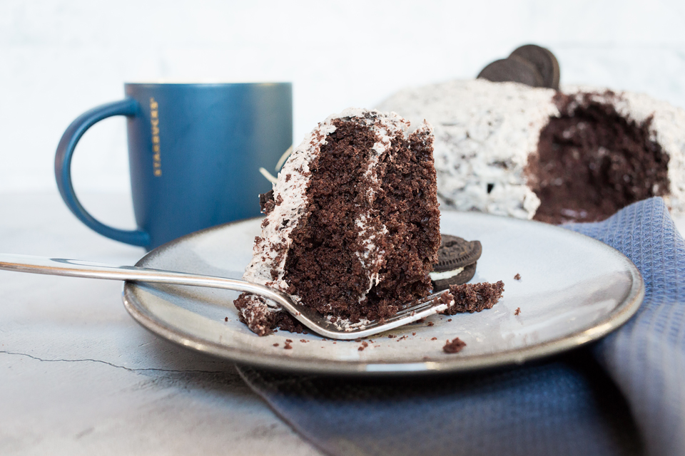 close up photo of oreo cake slice with blue mug