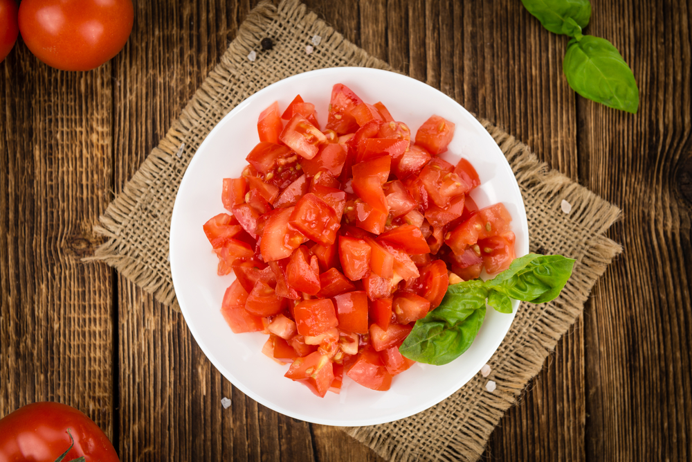 chopped tomatoes on a plate without seeds and basil 