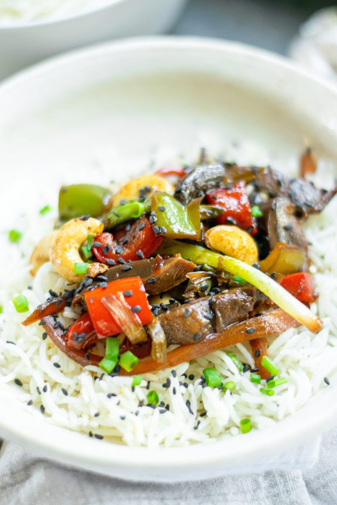 close up of spicy Kung Pao vegetables served on a bed of rice