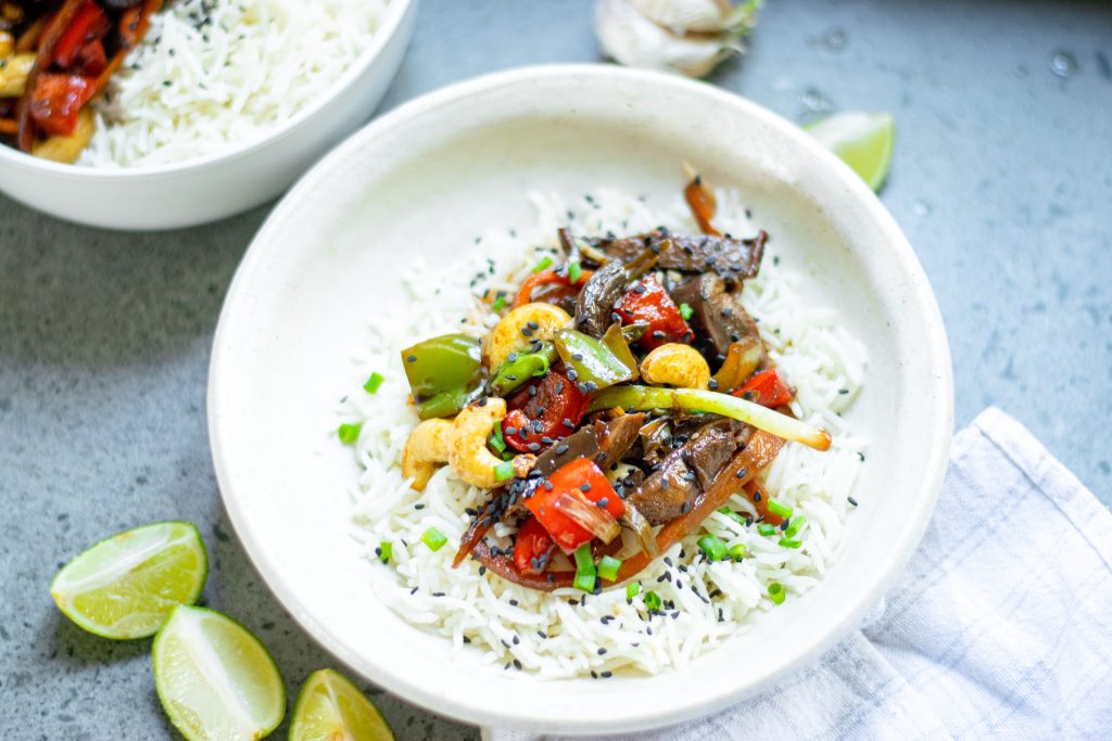 two bowls of vegetable kung pao with green onions