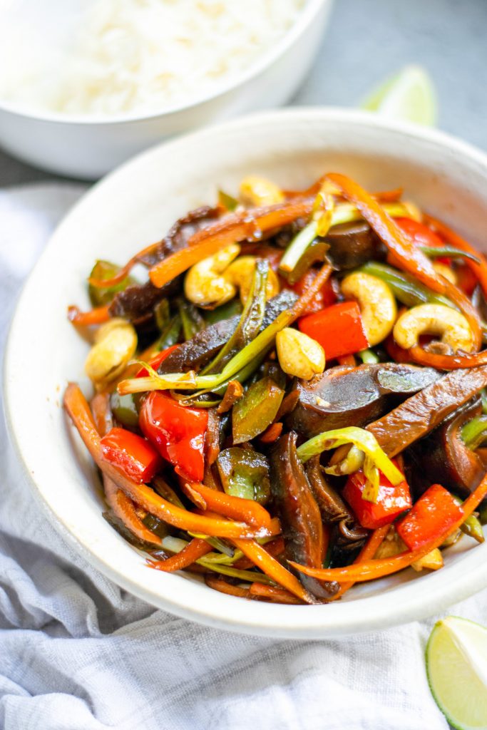 close up of Kung Pao vegetables with rice in the background