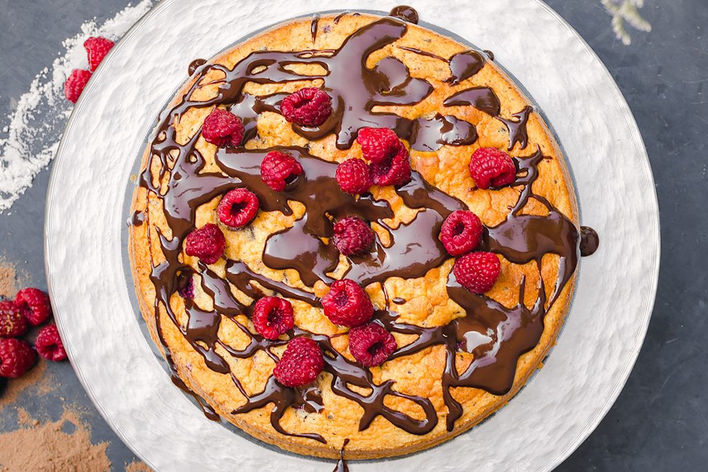 close up photo of chocolate raspberry cake with ganache