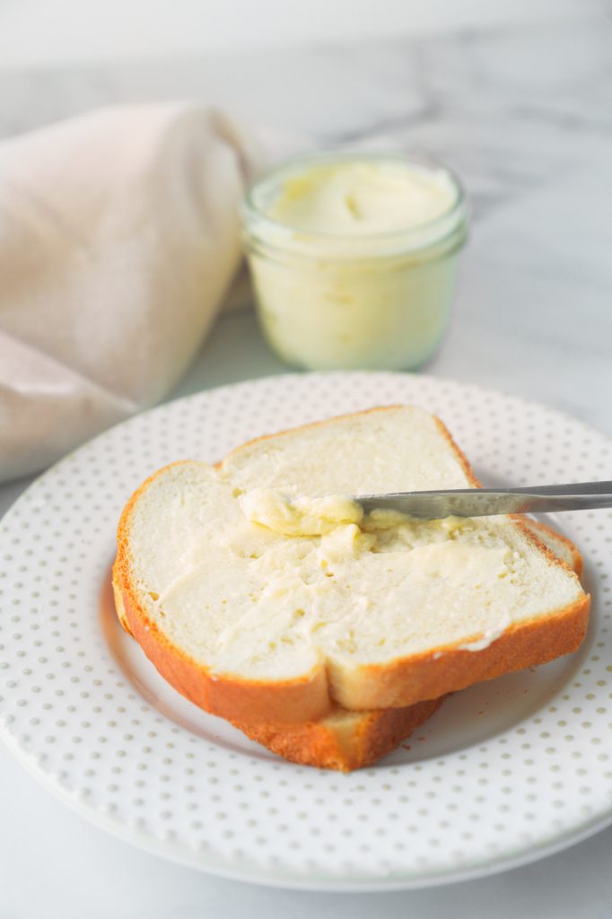 vegan butter spread on bread with container in the background