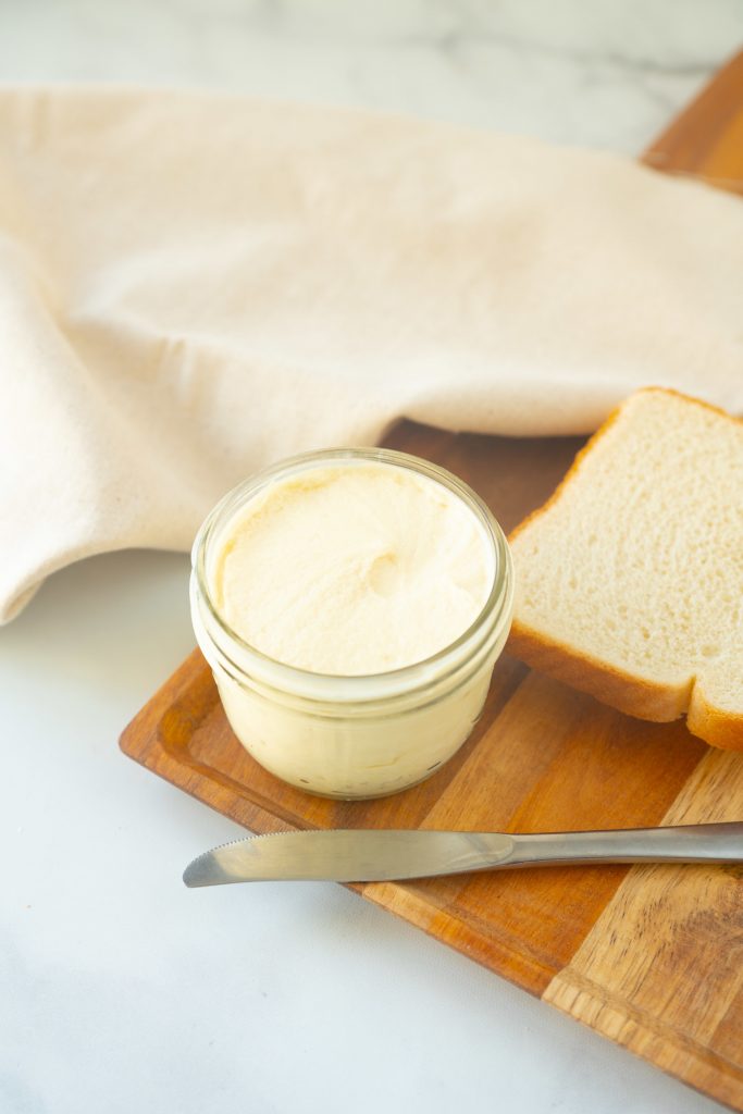 easy vegan butter in small tub with knife
