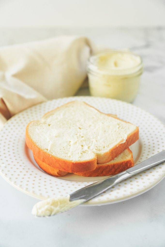 vegan butter on bread with knife laying on the side of plate