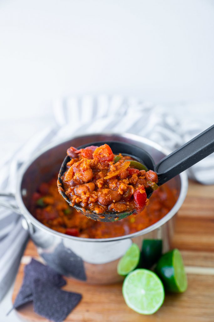 vegetarian chili in cooking pot with ladle