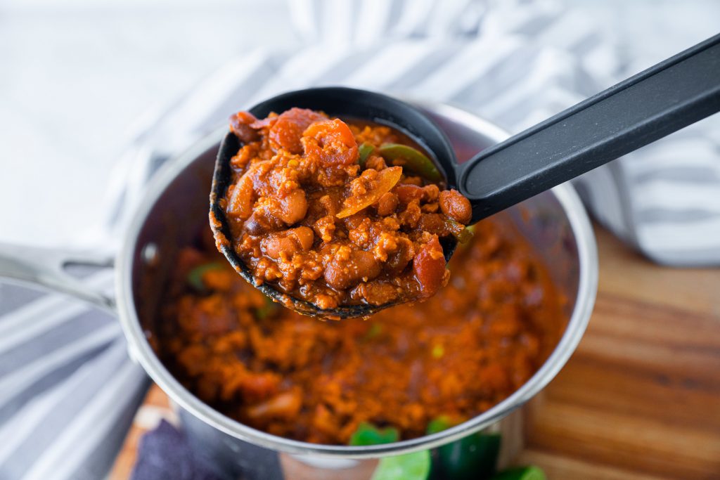 ladle scooping up vegetarian chili from pot