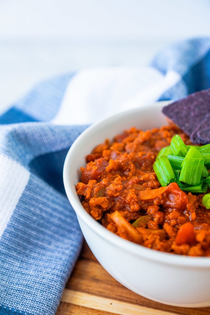 vegan chili recipe in bowl from the side with limes