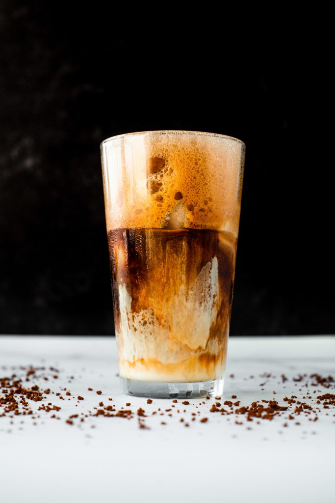greek frappe recipe in a tall glass with black background