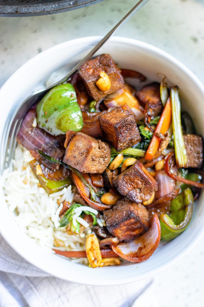 kung pao tofu with veggies over white rice