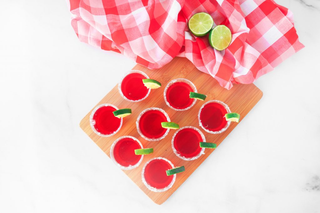 overhead shot of strawberry margarita vegan jello shots with lime 