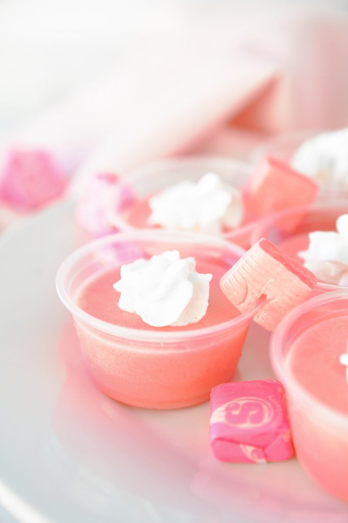 close up photo of pink starburst jello shots with starburst garnish